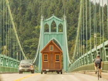Tiny House Traveling Across a Bridge Photo by Billy Ulmer