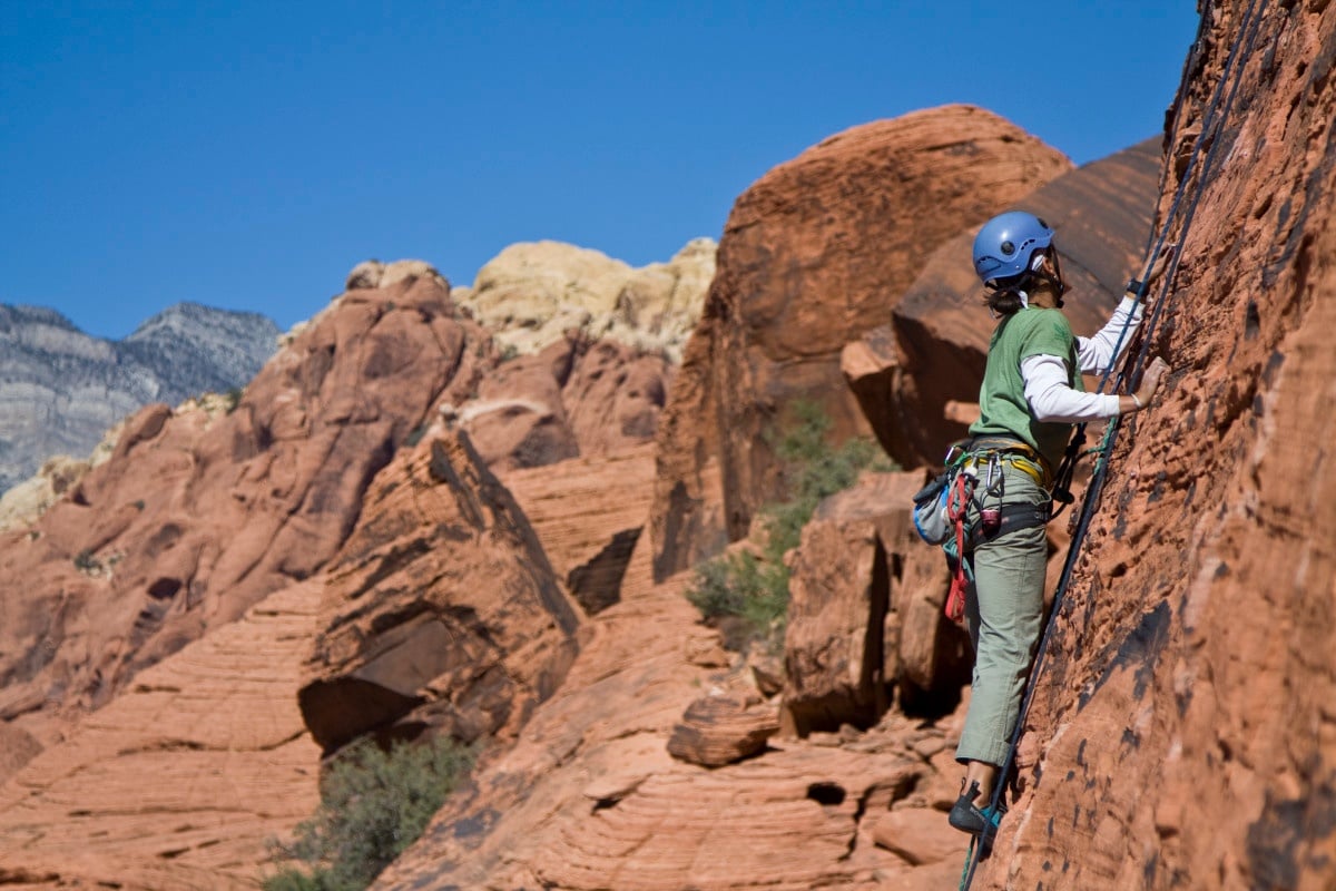 Rock climber scales a sandstone wall