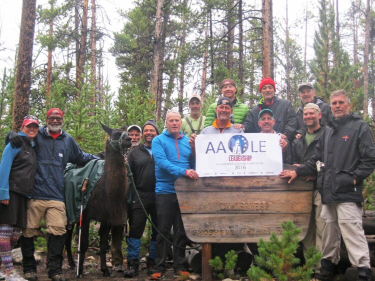 3 / 3 All American Leadership course participants smile together while on a week long backpacking, llama-supported expedition in the Wind River Mountain range.